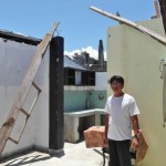 Ruben Aryap stands in his roofless house near the Tacloban airport.