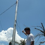 Ruben points at the power pole where his wife, Jocelyn and their daughter clung at the beginning of the storm.